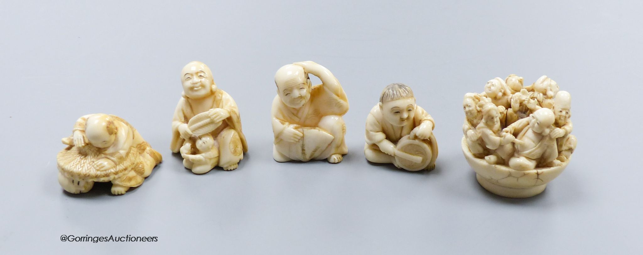 Five Japanese carved ivory netsukes, Meiji period, including an example of the seven gods of happiness, tallest 5cm